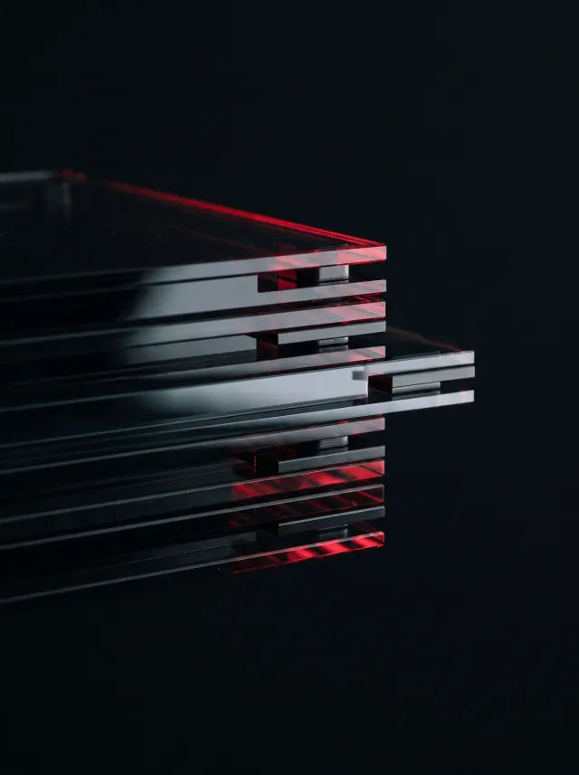 Stacked panes of dark smoked glass with red rim light